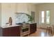 Kitchen boasts stainless gas range, white hood, and marble backsplash at 3330 Bruce Randolph Ave, Denver, CO 80205