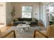 Sunlit living room with original hardwood floors, a large window, and a stylish sofa at 3330 Bruce Randolph Ave, Denver, CO 80205