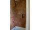Close-up of the walk-in shower featuring brown tiling and a sleek shower head at 3330 Bruce Randolph Ave, Denver, CO 80205