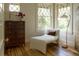 Sunlit sitting room with a chaise lounge, dresser, and windows with diamond-patterned panes at 3330 Bruce Randolph Ave, Denver, CO 80205