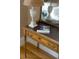 Close up of wood table with a marble lamp and gold trim mirror at 3330 Bruce Randolph Ave, Denver, CO 80205