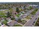 A neighborhood featuring a mix of housing styles, mature trees, and manicured lawns at 5477 E Asbury Ave, Denver, CO 80222