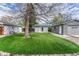 A beautiful artificial grass backyard with a shed, swing set, and trampoline at 5477 E Asbury Ave, Denver, CO 80222