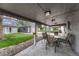 View of the backyard with a covered patio seating area and a large yard at 5477 E Asbury Ave, Denver, CO 80222
