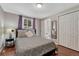 Cozy bedroom featuring a queen bed, plush pillows, and closet with mirrored door at 5477 E Asbury Ave, Denver, CO 80222