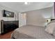Comfortable bedroom with a dresser, television and bed with a large patterned comforter at 5477 E Asbury Ave, Denver, CO 80222