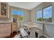 Charming breakfast nook with white benches, light wood table, and bright natural light from two windows at 5477 E Asbury Ave, Denver, CO 80222
