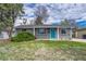 Charming single-story home with a grey brick facade, a bright blue front door, and well-maintained landscaping at 5477 E Asbury Ave, Denver, CO 80222