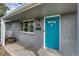 Charming home entrance featuring a bright blue door and well-kept grey brick facade at 5477 E Asbury Ave, Denver, CO 80222