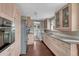 Bright kitchen with granite countertops, stainless steel appliances and wood cabinets at 5477 E Asbury Ave, Denver, CO 80222