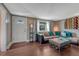 Comfortable living room featuring a plush sofa with accent pillows, stylish decor, and natural light at 5477 E Asbury Ave, Denver, CO 80222