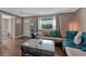 Comfortable living room with sectional sofa, large window and rustic coffee table at 5477 E Asbury Ave, Denver, CO 80222