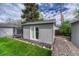Shed in backyard features rock landscaping, artificial turf, and a nearby trampoline at 5477 E Asbury Ave, Denver, CO 80222