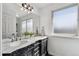 Bathroom featuring a dual vanity with a marble countertop, stylish mirrors, and modern lighting at 19431 E Hamilton Pl, Aurora, CO 80013