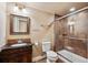 Cozy bathroom with a dark wood vanity, toilet, and a glass-enclosed tile shower at 19431 E Hamilton Pl, Aurora, CO 80013