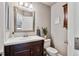 Cozy half-bathroom featuring a dark wood vanity with granite countertop at 19431 E Hamilton Pl, Aurora, CO 80013