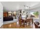 Open-concept dining area with hardwood floors, natural light, and a view of the living room at 19431 E Hamilton Pl, Aurora, CO 80013
