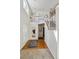 Bright foyer with hardwood floors, a staircase, and a view of the upper level, creating an inviting entrance at 19431 E Hamilton Pl, Aurora, CO 80013