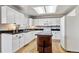 Modern kitchen with white cabinets, an island with seating, and black countertops at 19431 E Hamilton Pl, Aurora, CO 80013