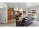 Comfortable living room featuring a fireplace, built-in storage, and a door that leads to the exterior at 19431 E Hamilton Pl, Aurora, CO 80013
