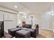 Cozy finished basement with a sectional sofa, plush carpet, and ample lighting at 19431 E Hamilton Pl, Aurora, CO 80013