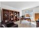 Spacious home office with large bookshelf and elegant desk area, great natural light at 19431 E Hamilton Pl, Aurora, CO 80013