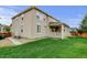 Exterior view of a home showcasing a large backyard and covered patio at 2454 Ambience Ln, Castle Rock, CO 80109