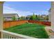 View of a well-maintained backyard featuring a green lawn and a wood fence at 2454 Ambience Ln, Castle Rock, CO 80109
