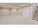 Finished basement with plush carpet, storage closet, and stairway access to the upper levels of the home at 2454 Ambience Ln, Castle Rock, CO 80109