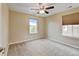 Neutral bedroom featuring carpeted floors, a ceiling fan, and natural light from two windows at 2454 Ambience Ln, Castle Rock, CO 80109