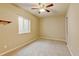 Cozy bedroom with natural light from a window, featuring plush carpeting and a ceiling fan at 2454 Ambience Ln, Castle Rock, CO 80109