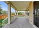 Spacious covered patio with wood floors, support columns, and backyard views at 2454 Ambience Ln, Castle Rock, CO 80109