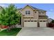 Beautiful two-story home showcasing a manicured lawn and a spacious three-car garage at 2454 Ambience Ln, Castle Rock, CO 80109