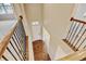 Bright foyer features hardwood floors and a view of the front door from the upper level at 2454 Ambience Ln, Castle Rock, CO 80109