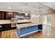 Modern kitchen featuring stainless steel appliances, a large island, and dark cabinetry at 2454 Ambience Ln, Castle Rock, CO 80109