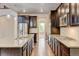 Long galley kitchen with granite countertops, stainless steel appliances, and ample storage at 2454 Ambience Ln, Castle Rock, CO 80109