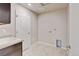 Bright laundry room featuring tile flooring, utility sink with cabinet, and convenient washer/dryer hookups at 2454 Ambience Ln, Castle Rock, CO 80109