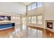 Open-concept living room and kitchen with hardwood floors, fireplace, and lots of natural light at 2454 Ambience Ln, Castle Rock, CO 80109