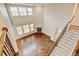 Open-concept living room with high ceilings, hardwood floors, fireplace, and large windows at 2454 Ambience Ln, Castle Rock, CO 80109