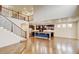 Open floor plan showcases the staircase, loft area, kitchen island, and hardwood floors at 2454 Ambience Ln, Castle Rock, CO 80109