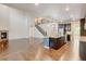 Spacious open layout with hardwood floors, fireplace, kitchen island and staircase at 2454 Ambience Ln, Castle Rock, CO 80109
