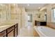 Luxurious main bathroom features dual vanities, soaking tub, tiled shower with glass doors, and neutral decor at 2454 Ambience Ln, Castle Rock, CO 80109