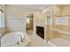 Elegant main bathroom showcasing a soaking tub, walk-in shower, dual sinks, and access to a large closet at 2454 Ambience Ln, Castle Rock, CO 80109