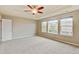 Inviting main bedroom features a tray ceiling, large windows, plush carpeting, and neutral color scheme at 2454 Ambience Ln, Castle Rock, CO 80109