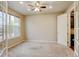 Well-lit home office featuring carpet, a ceiling fan, and glass panel doors at 2454 Ambience Ln, Castle Rock, CO 80109