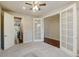 Bright room featuring glass-paneled doors, ceiling fan and neutral carpet flooring at 2454 Ambience Ln, Castle Rock, CO 80109