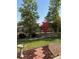 Landscaped backyard featuring a lush lawn, trees, and a charming fence creating a serene outdoor space at 7472 Iridium Way, Castle Rock, CO 80108