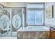 Bathroom with tile flooring, enclosed glass shower, and soaking tub near a large sunny window at 7472 Iridium Way, Castle Rock, CO 80108