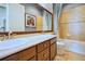 Bright bathroom features double sinks with a large mirror and a shower and tub combination at 7472 Iridium Way, Castle Rock, CO 80108