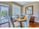 Dining room with hardwood floors, a large window, and a mirrored sideboard at 7472 Iridium Way, Castle Rock, CO 80108